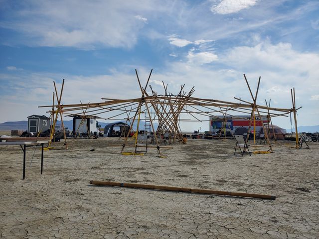 The raise: the bamboo frame standing, poles still laid out in front.