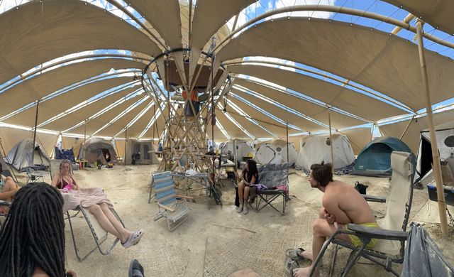 Afternoon inside: chairs out of the sun, tents around the edge.