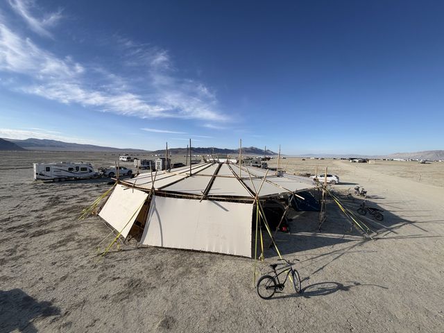 The pavilion from the playa, its white skin catching the morning sun.