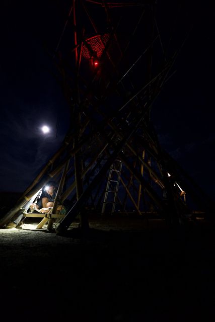 Red ring, white moon, one headlamp: night one on the trunk.