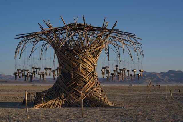 The Resonance Tree at first light, lanterns still, playa quiet.