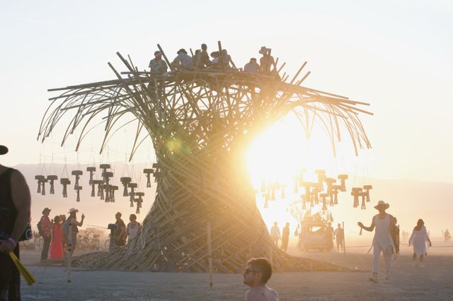 Open to the playa: sunset, a full platform and a crowd below.